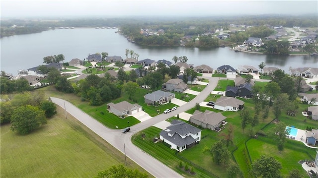 birds eye view of property with a water view