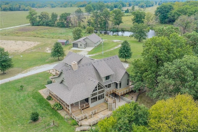 birds eye view of property featuring a water view and a rural view