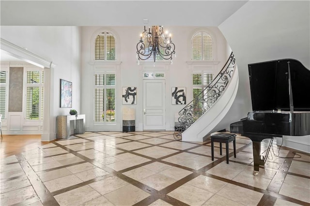 entrance foyer featuring an inviting chandelier, a high ceiling, and a wealth of natural light