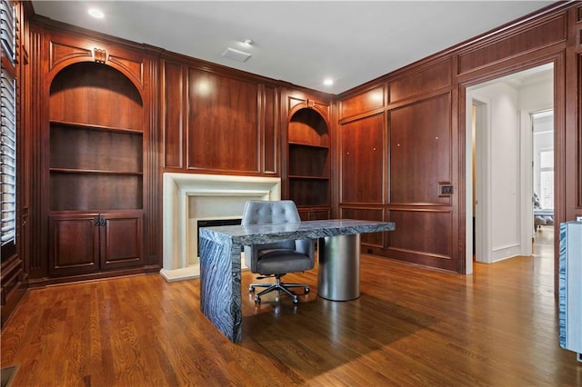 office with built in shelves, hardwood / wood-style flooring, and crown molding