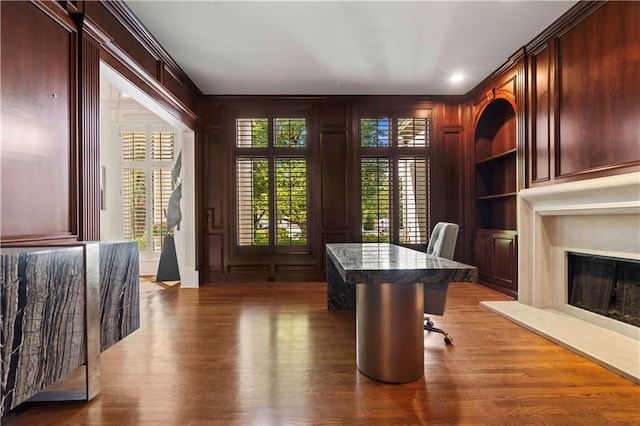 office area featuring ornamental molding, built in features, and dark wood-type flooring