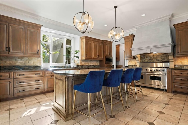 kitchen with a kitchen breakfast bar, a notable chandelier, stainless steel appliances, a center island, and custom exhaust hood