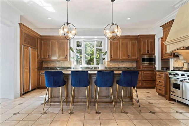 kitchen featuring a kitchen island, a chandelier, stainless steel appliances, and custom exhaust hood