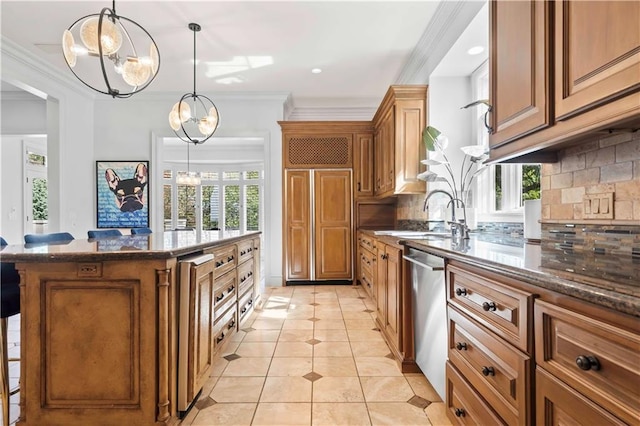 kitchen with sink, tasteful backsplash, a kitchen island, stainless steel dishwasher, and decorative light fixtures