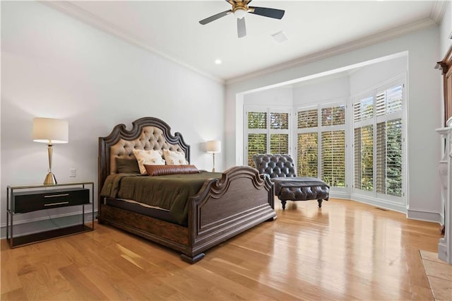 bedroom with crown molding, light wood-type flooring, and ceiling fan