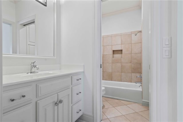 full bathroom featuring vanity, tile patterned flooring, toilet, and tiled shower / bath