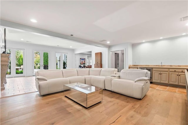 living room featuring sink and light hardwood / wood-style floors