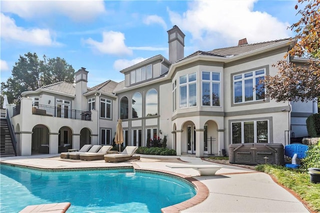 back of house with a balcony and a patio area