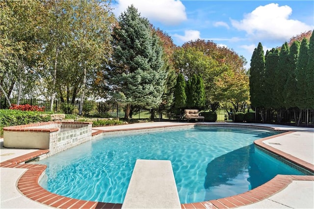 view of pool with a diving board