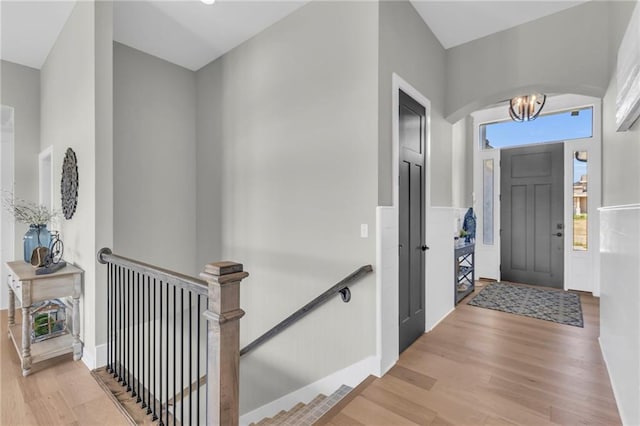 entryway with light hardwood / wood-style floors and a chandelier