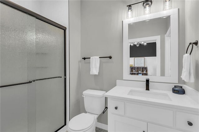 bathroom featuring vanity, toilet, and an enclosed shower