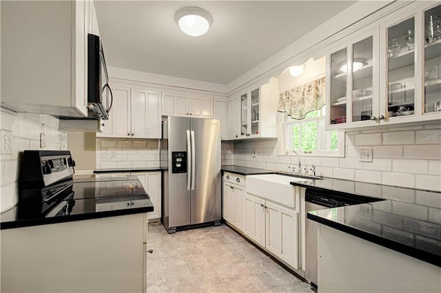 kitchen with decorative backsplash, appliances with stainless steel finishes, and white cabinets