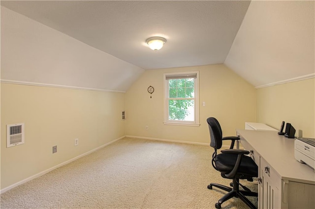 unfurnished office featuring vaulted ceiling and light colored carpet