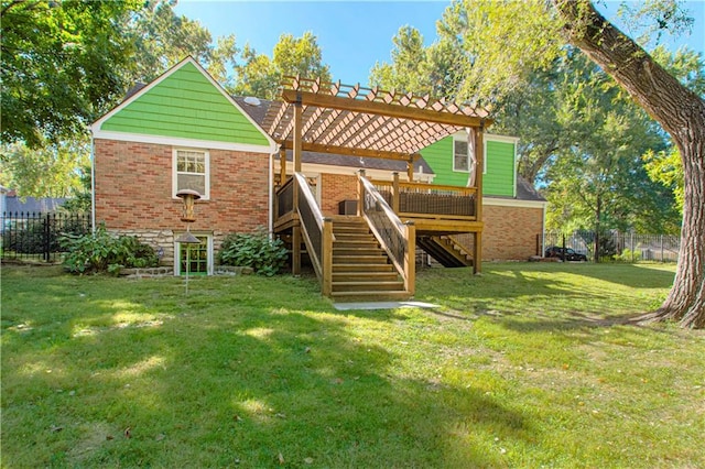 rear view of house with a yard, a deck, and a pergola