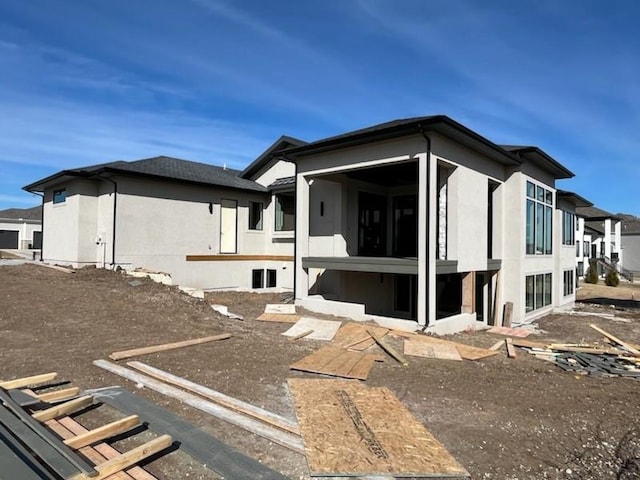 exterior space with a sunroom and stucco siding