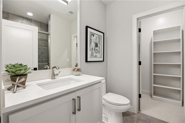 12303 W 167th Ter, Overland Park, KS 66221 - bathroom featuring vanity, toilet, and a tile shower