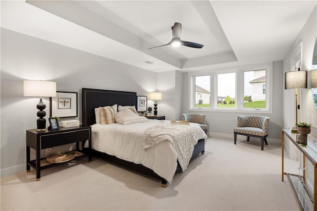 12303 W 167th Ter, Overland Park, KS 66221 - bedroom with baseboards, light carpet, a tray ceiling, and ceiling fan