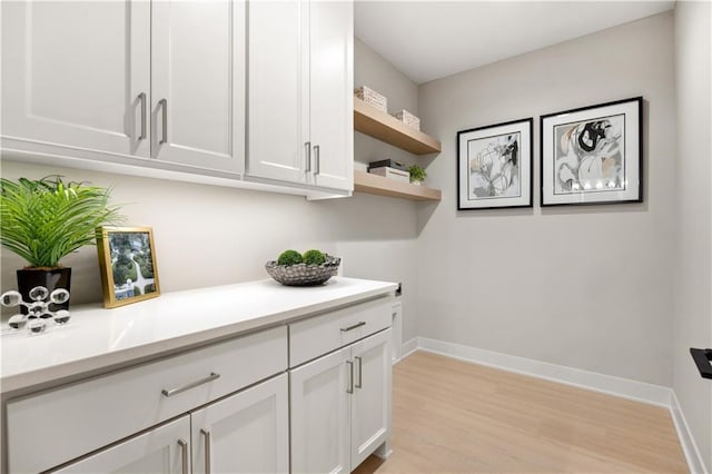 12303 W 167th Ter, Overland Park, KS 66221 - laundry area featuring light wood-style floors and baseboards
