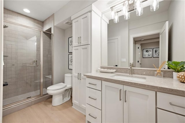 12303 W 167th Ter, Overland Park, KS 66221 - bathroom with vanity, toilet, a stall shower, and wood finished floors