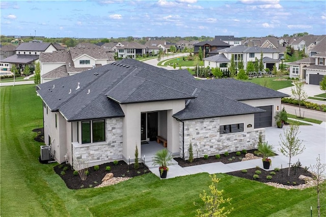 12303 W 167th Ter, Overland Park, KS 66221 - back of house featuring stone siding, a residential view, central AC unit, and a shingled roof