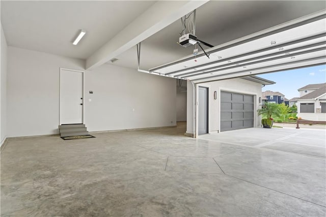 12303 W 167th Ter, Overland Park, KS 66221 - garage with ceiling fan, a garage door opener, and baseboards