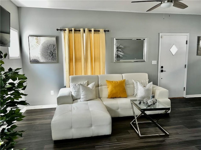 living room featuring ceiling fan and dark hardwood / wood-style flooring