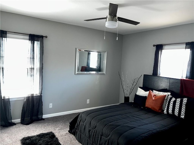 carpeted bedroom with multiple windows and ceiling fan