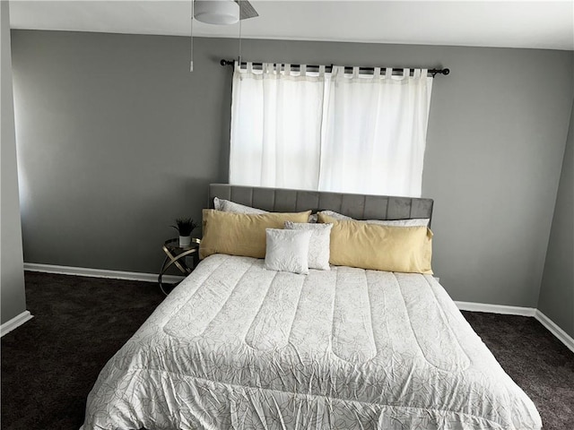 bedroom featuring dark carpet and ceiling fan