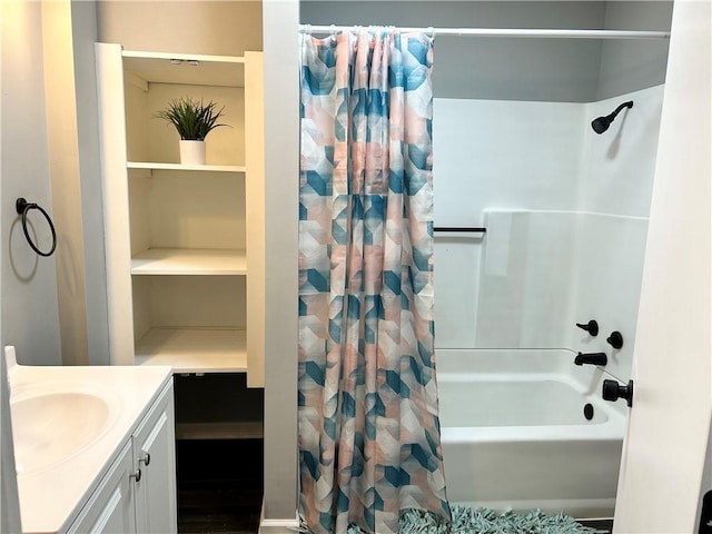 bathroom featuring shower / bath combo with shower curtain, wood-type flooring, and vanity