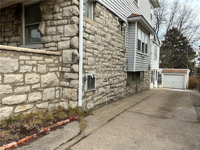 view of home's exterior featuring a garage and an outbuilding