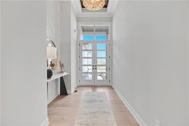 foyer entrance with french doors and light hardwood / wood-style floors