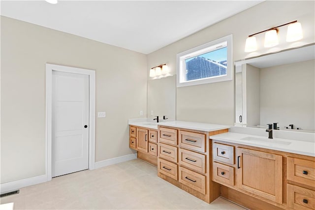 full bathroom with visible vents, vanity, and baseboards