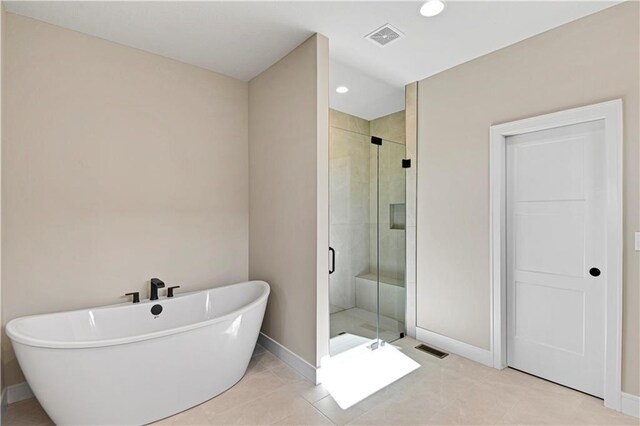 bathroom with a stall shower, baseboards, visible vents, and a soaking tub