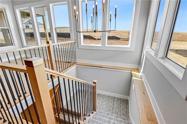 sunroom / solarium with a wealth of natural light and an inviting chandelier