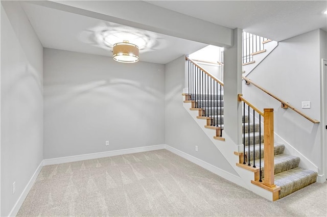 interior space with baseboards and carpet flooring