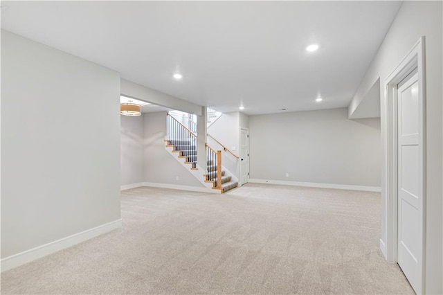 finished below grade area featuring stairs, baseboards, carpet flooring, and recessed lighting