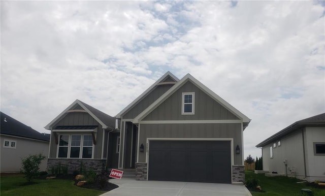 22023 W 94th St, Lenexa, KS 66220 - craftsman inspired home featuring board and batten siding, stone siding, driveway, and a garage