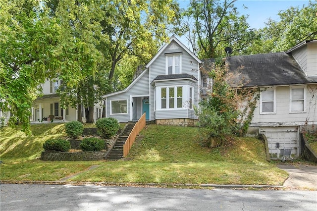 view of front of property featuring a front lawn and central AC unit