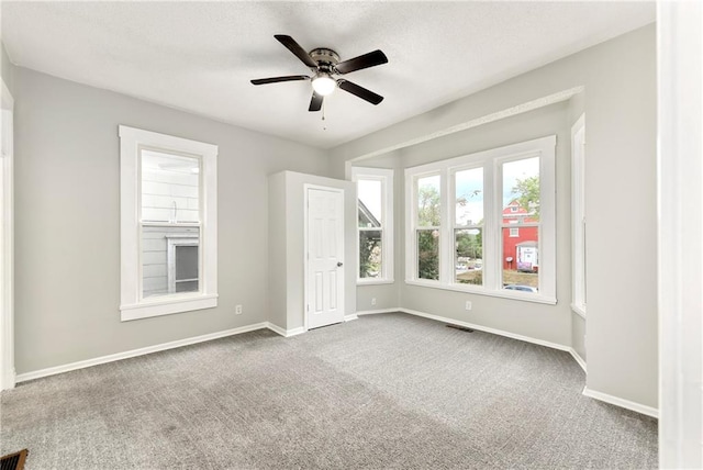 empty room featuring carpet and ceiling fan