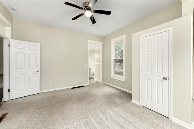 unfurnished bedroom with ceiling fan and light carpet