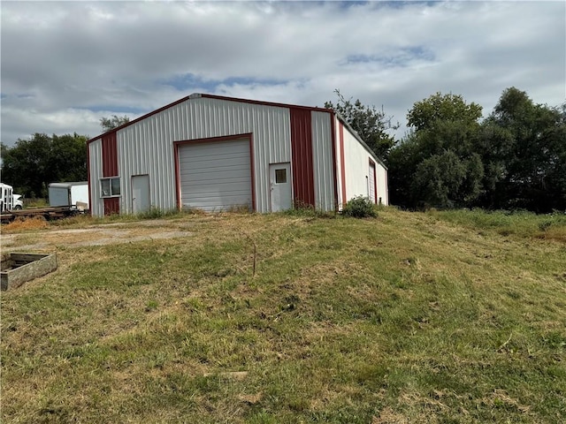 view of outbuilding with a lawn and a garage