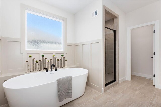 bathroom featuring separate shower and tub