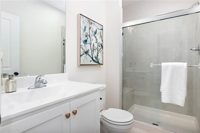 bathroom with walk in shower, vanity, and toilet