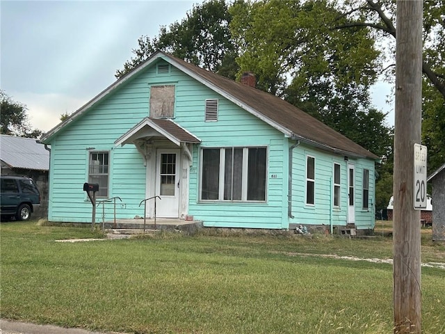 bungalow-style house with a front yard