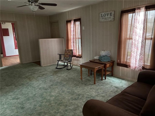 sitting room featuring carpet and ceiling fan