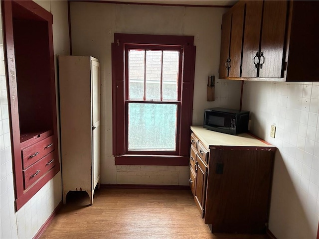 kitchen featuring light hardwood / wood-style flooring and tile walls