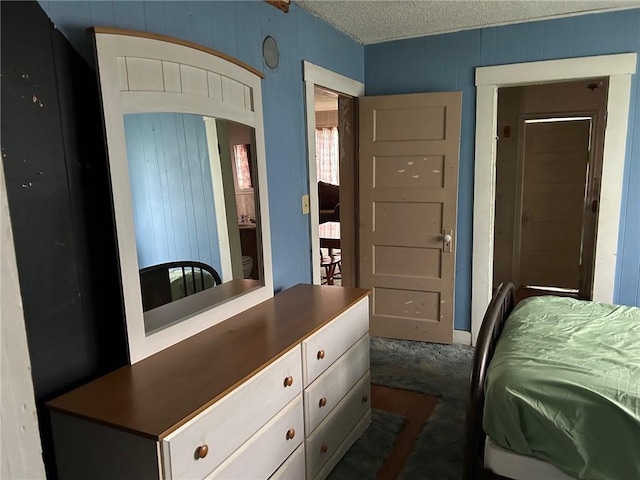 carpeted bedroom featuring a textured ceiling