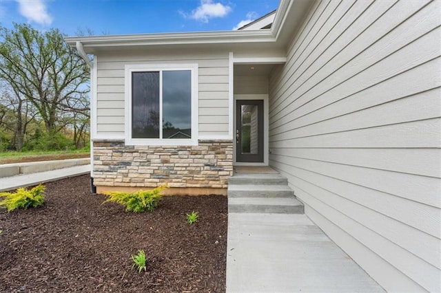 view of exterior entry featuring stone siding