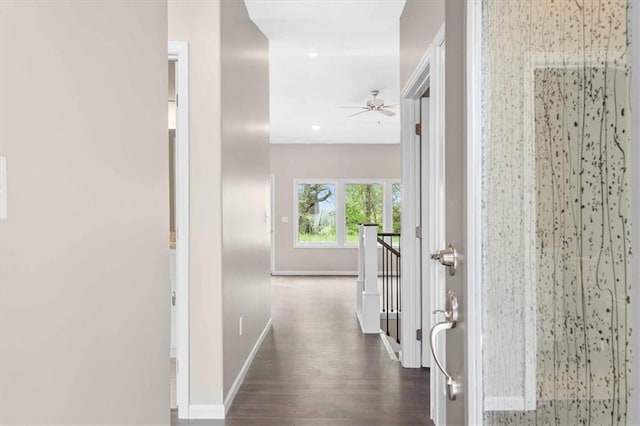 hallway featuring baseboards, recessed lighting, dark wood-style floors, and an upstairs landing