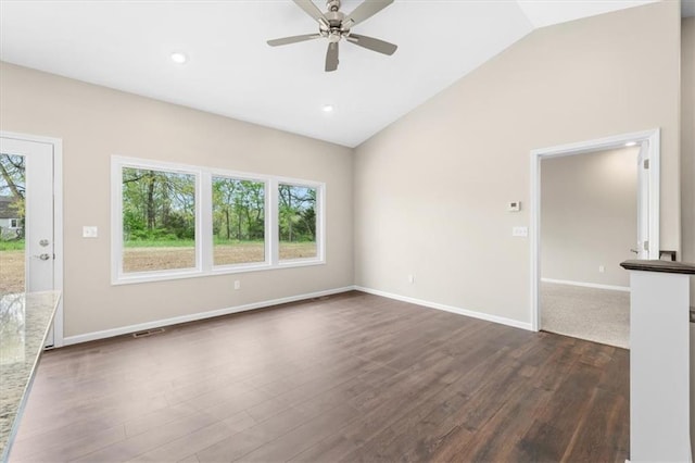 unfurnished living room with visible vents, lofted ceiling, baseboards, dark wood-type flooring, and a ceiling fan